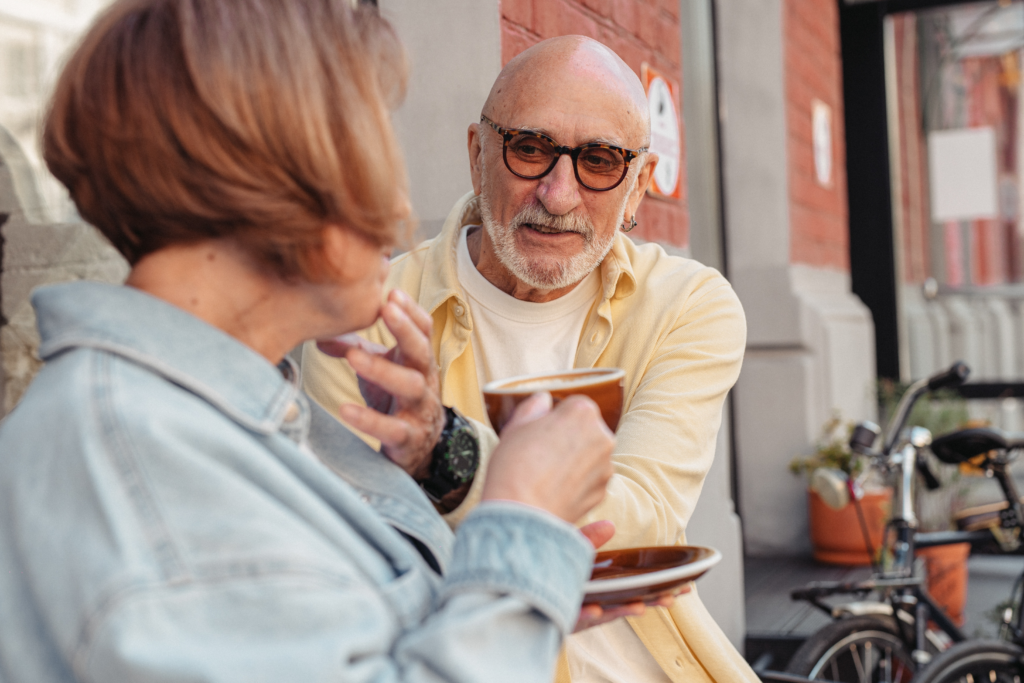 Man helping wife drink tea